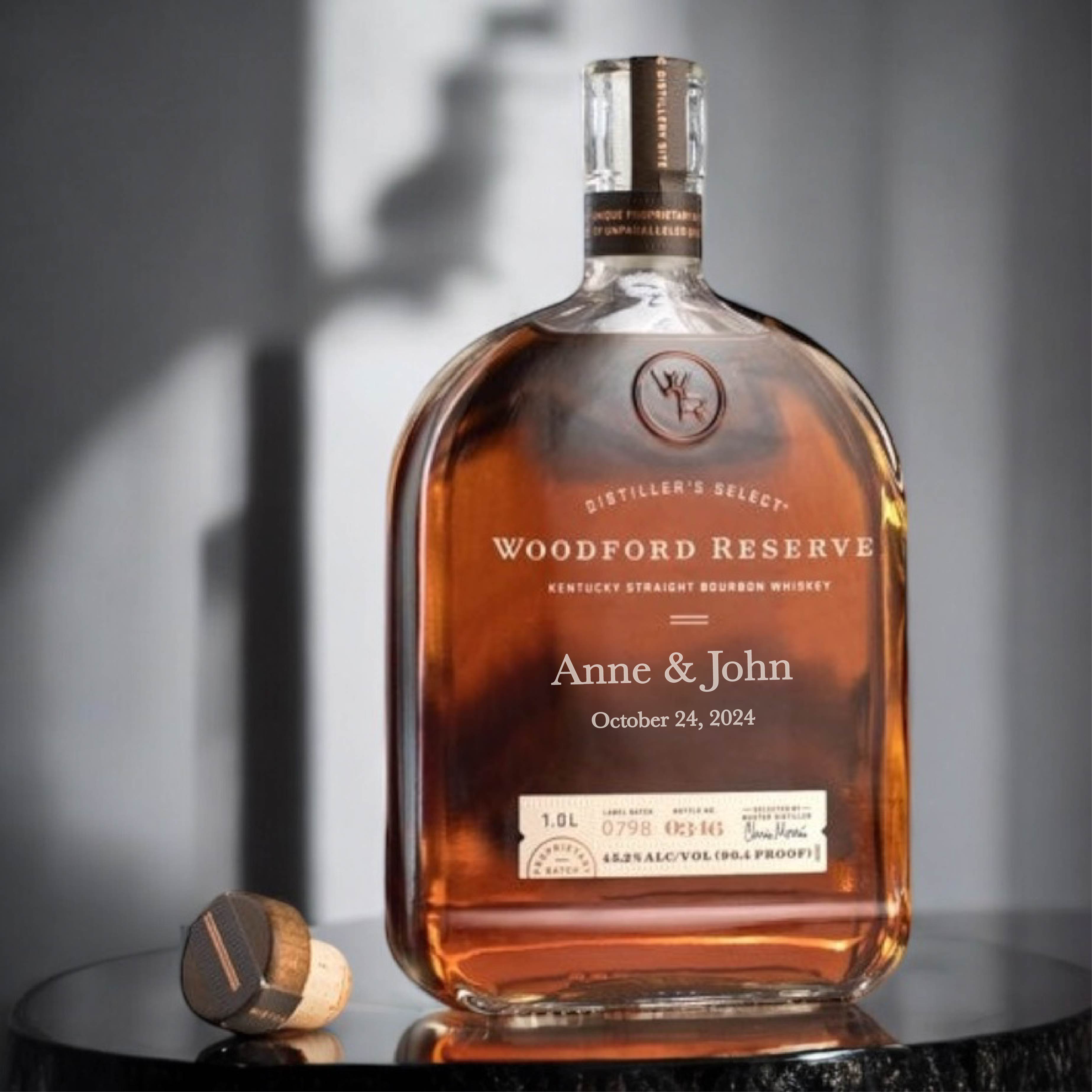 Deep etched glass whiskey bottle personalized with names and date, highlighting premium glass etching for gifts and special occasions.