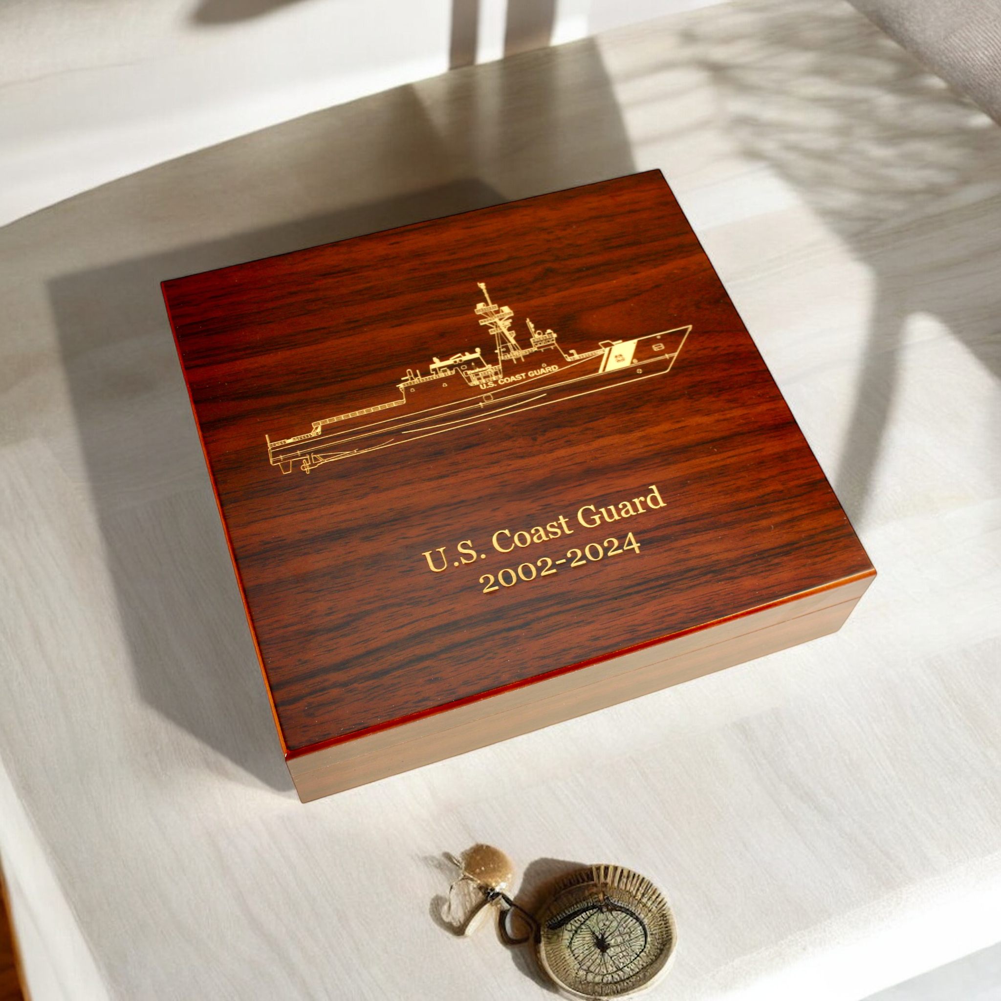 Laser engraved wood box featuring a U.S. Coast Guard ship and service years, showcasing custom engraving for awards and recognition.