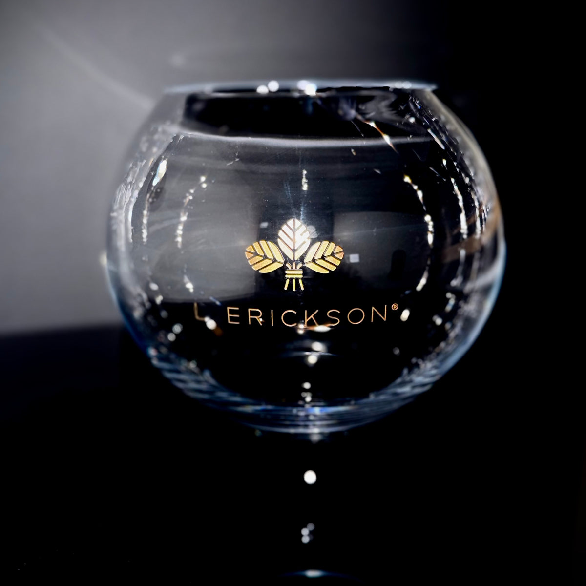 Round glass bowl personalized with the Erickson logo and finished with gold color fill.