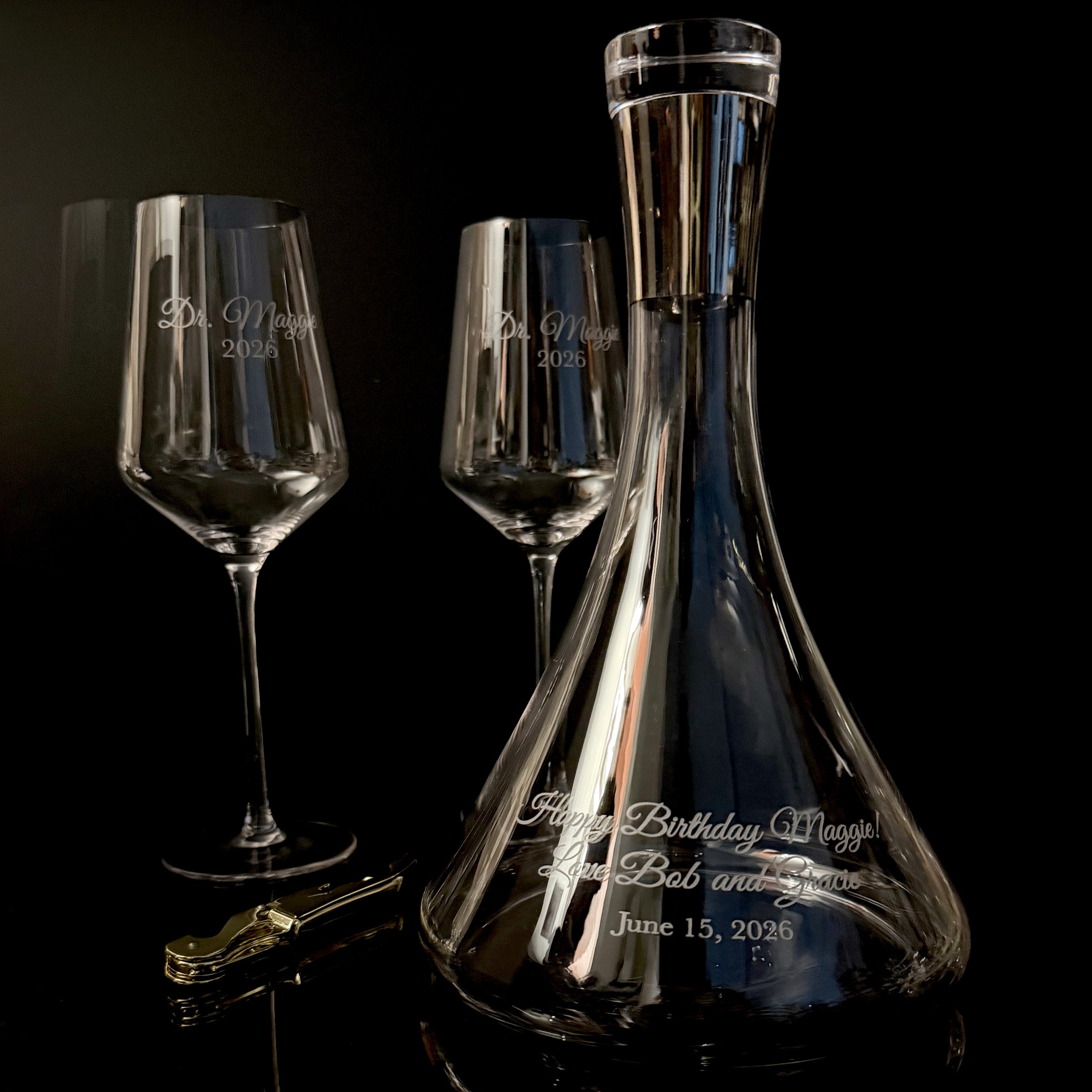 Personalized wine decanter and glasses on a dark background