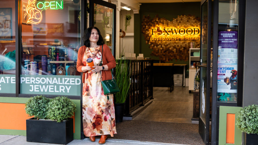 Joanna Lis, founder of Foxwood Engraving, standing outside her downtown Renton engraving studio and retail shop