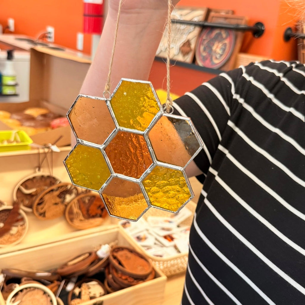 Finished handmade stained-glass suncatchers created during a Salty Bird Glass workshop at Foxwood Engraving.