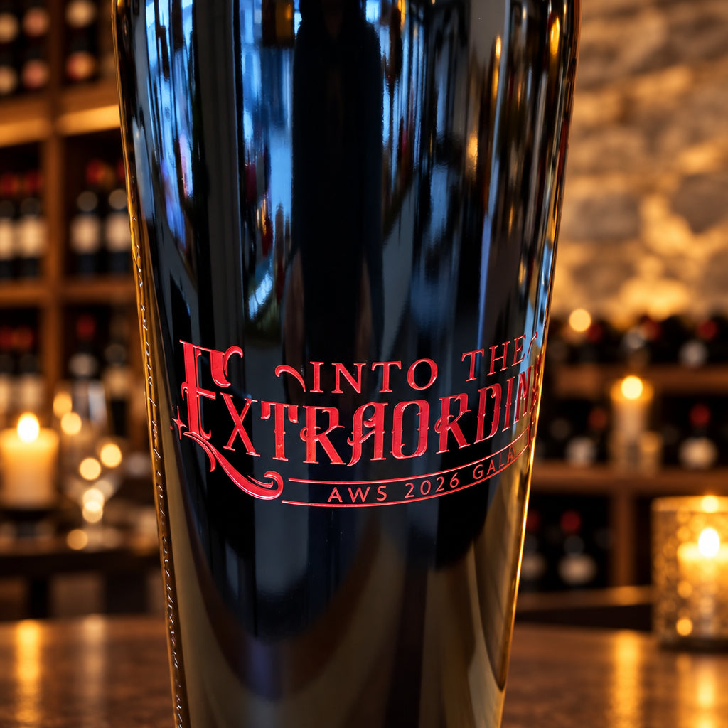 Close-up of custom red engraving on a large-format wine bottle