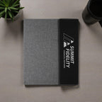 Gray and black case with logo on a wooden surface.