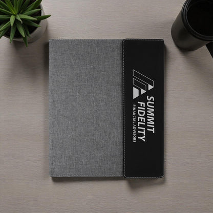 Gray and black case with logo on a wooden surface.