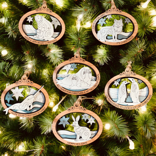 Foxwood Engraving Arctic Animals ornament collection featuring hand-painted wood designs.
