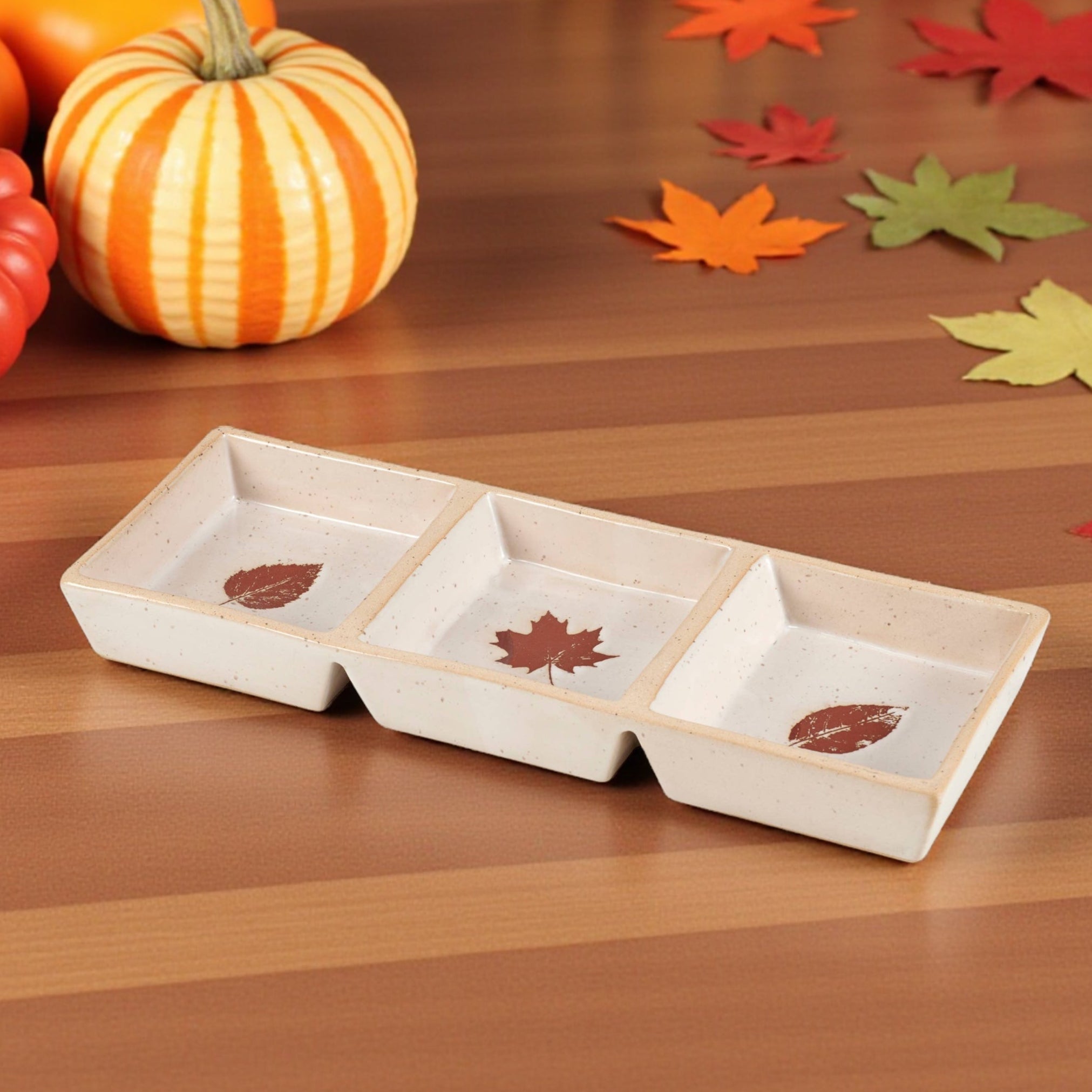 Fall-themed ceramic serving dish with three sections and leaf designs