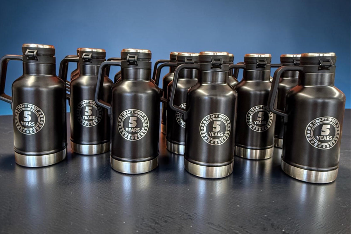 Group of black insulated growlers engraved with the Craft West five-year anniversary logo for a coordinated recognition order.