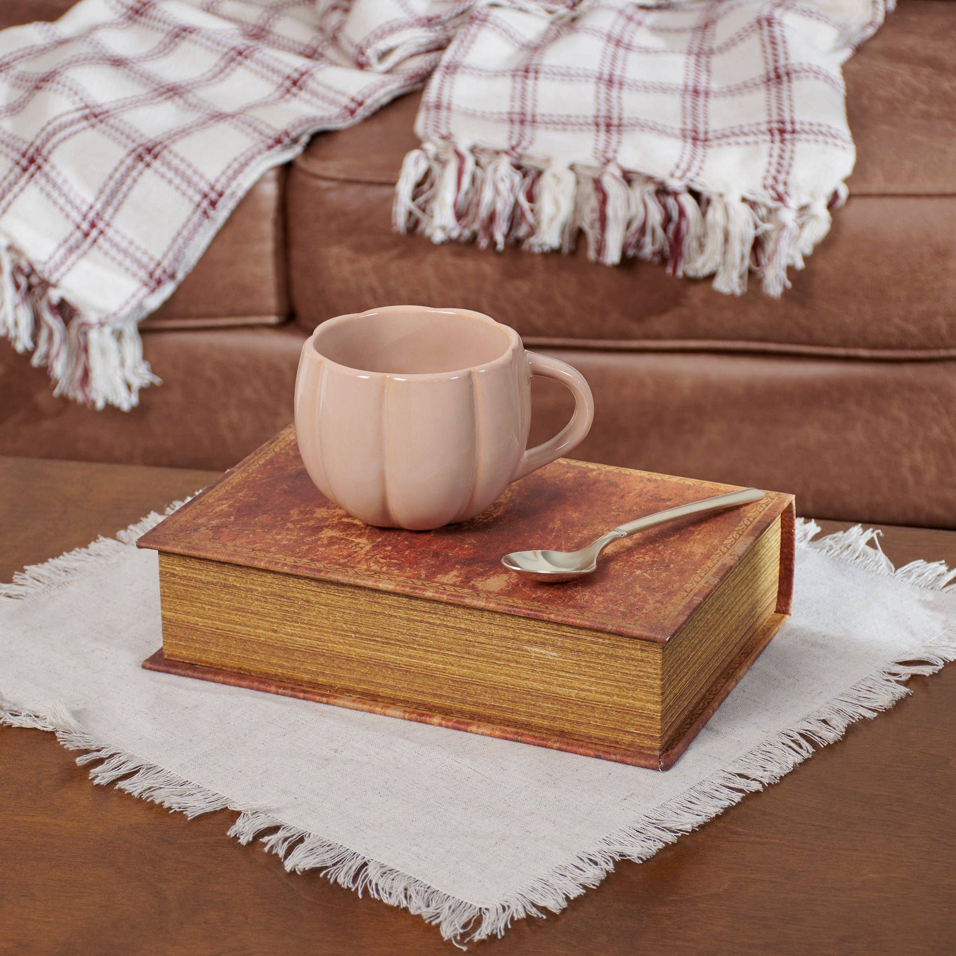 Ceramic pumpkin coffee mug perfect for fall beverages.