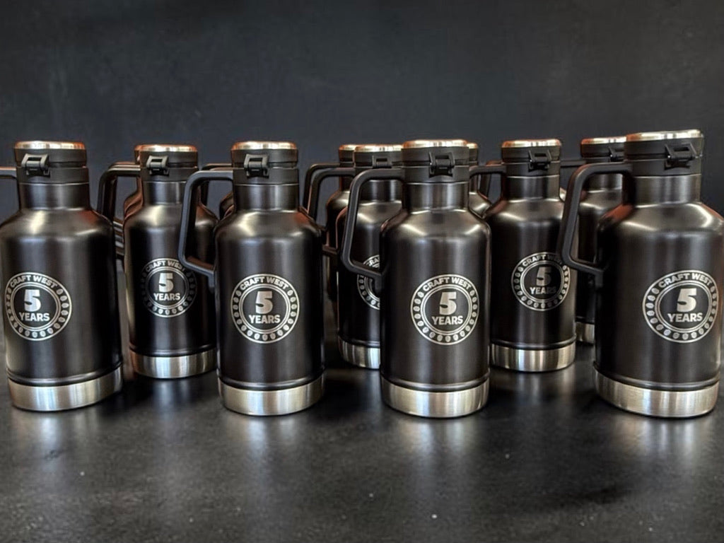 Custom branded drinkware including engraved tumblers, mugs, and water bottles with company logos for employee gifts and promotional events.