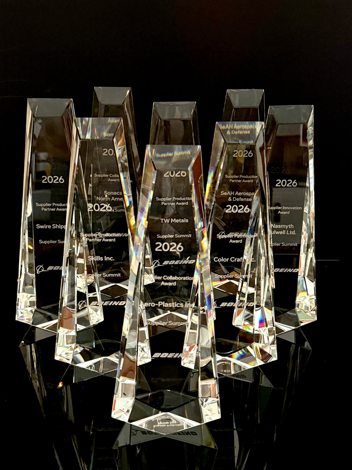 Collection of custom engraved crystal supplier awards created for corporate recognition program.