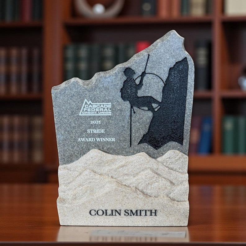 Custom granite achievement award with detailed engraved artwork and recipient name