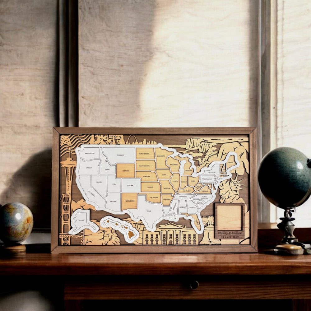 Wooden map of the United States on a wooden surface with a globe in the background