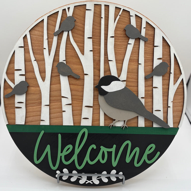DIY wooden welcome sign with birch trees and chickadee design.