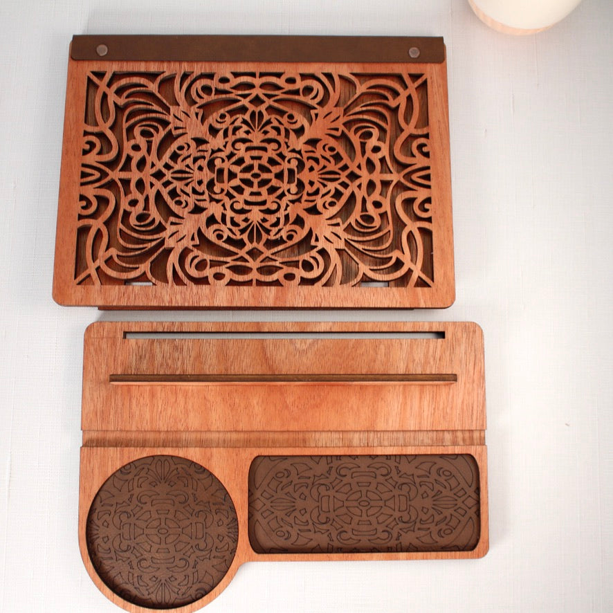 Top-down view of engraved wooden book valet with built-in mug holder