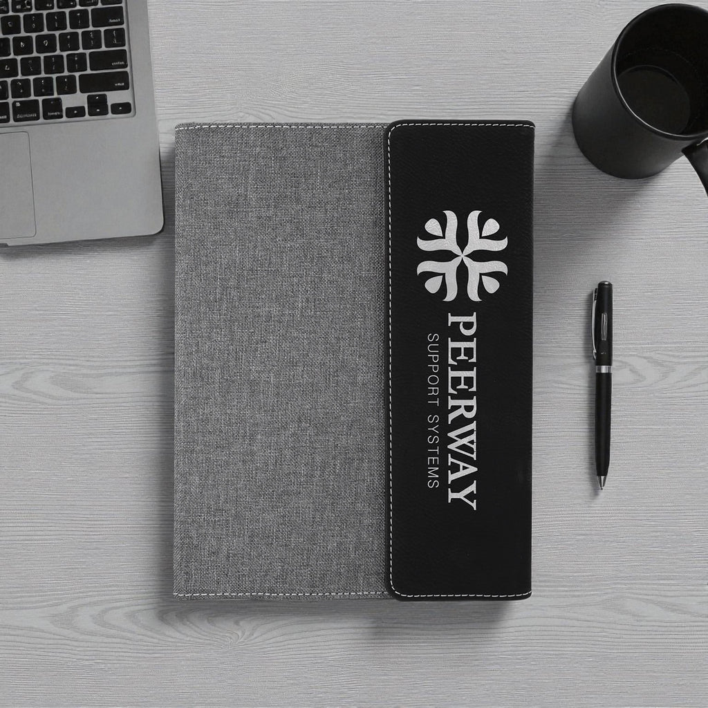 Engraved vegan leather notebook with stitched fabric design and refillable pages.