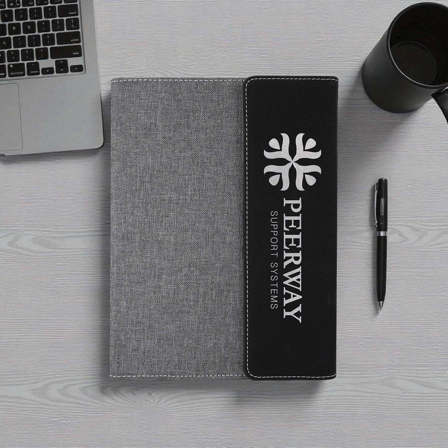 Engraved vegan leather notebook with stitched fabric design and refillable pages.