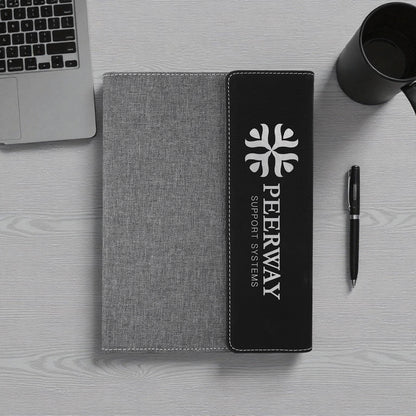 Engraved vegan leather notebook with stitched fabric design and refillable pages.