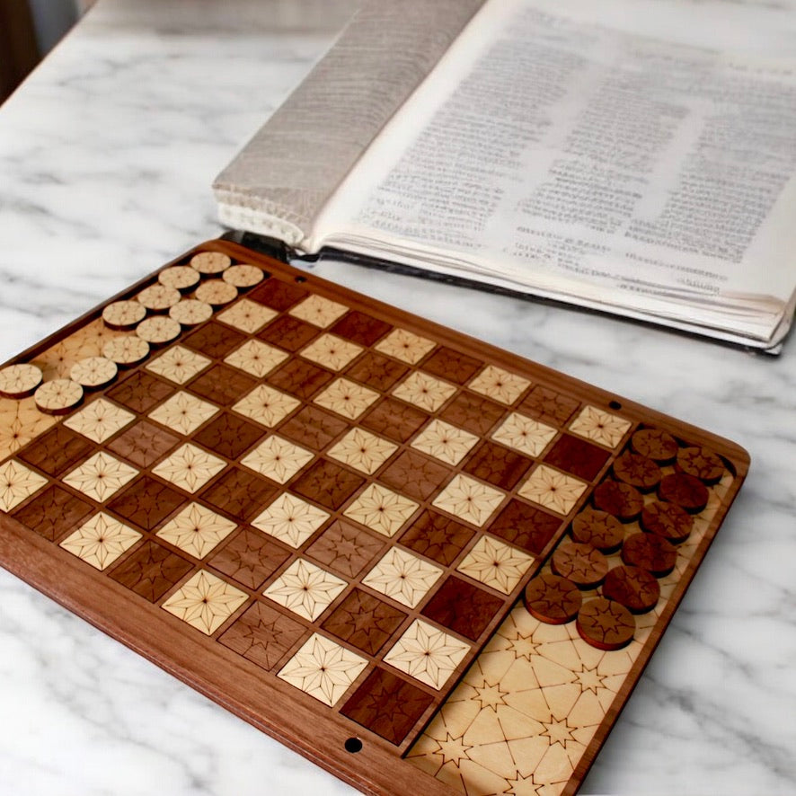 Closeup view of engraved star pattern on handcrafted Checkers board.