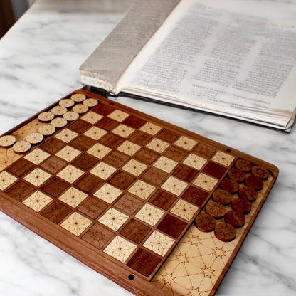 Closeup view of engraved star pattern on handcrafted Checkers board.
