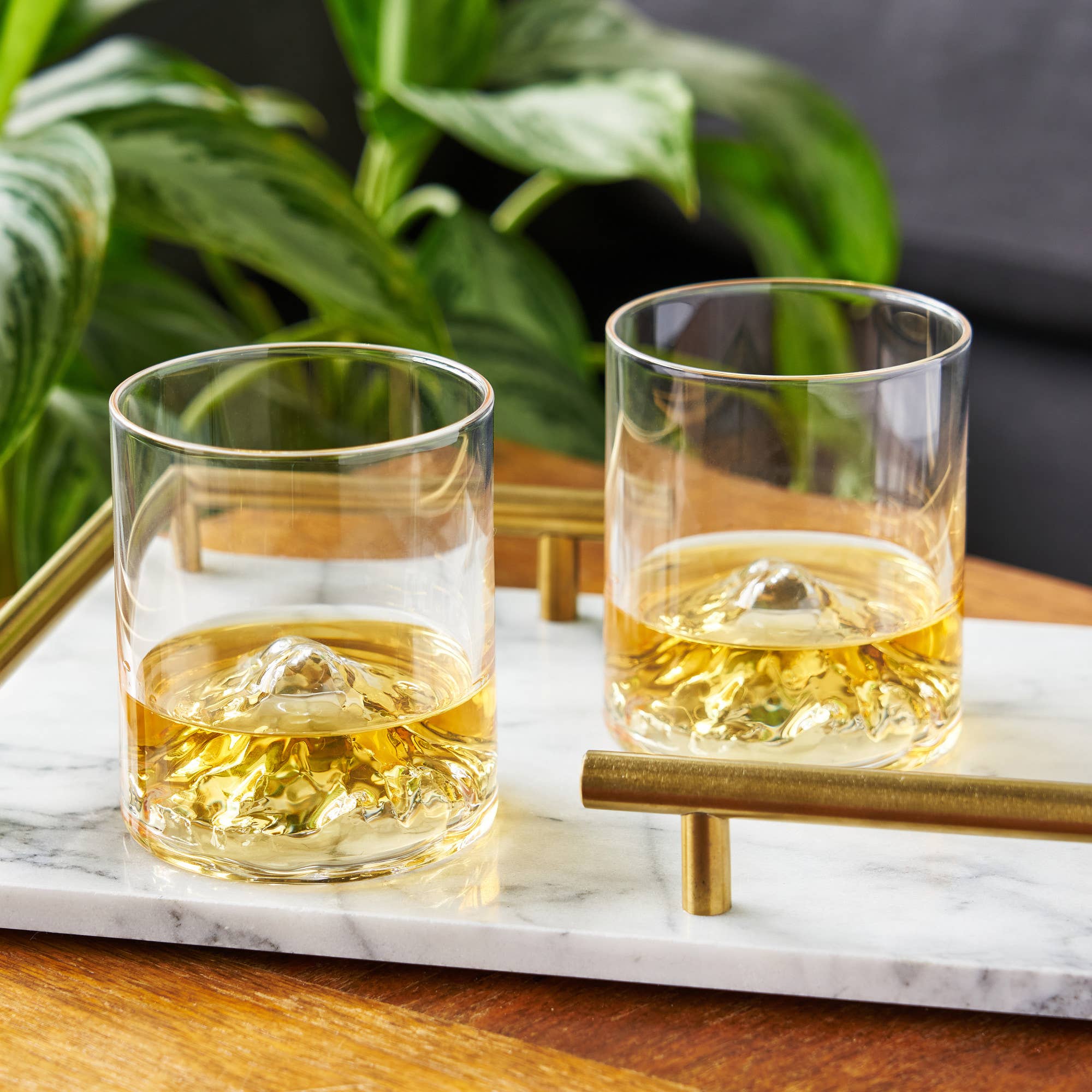 Close up of crystal whiskey glass with mountain design
