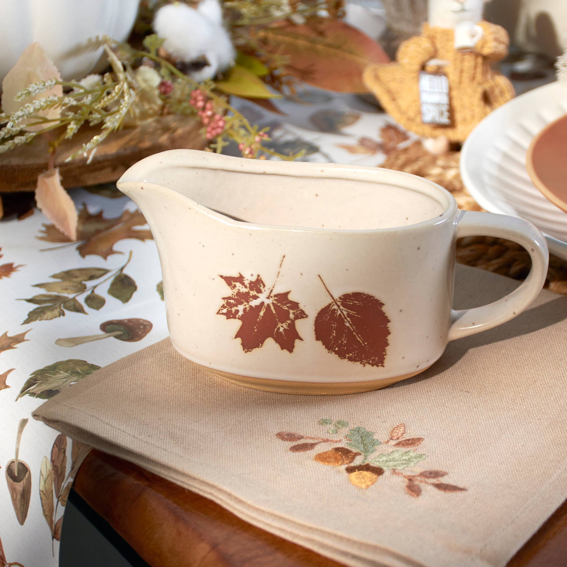 Cream stoneware gravy boat with brown leaf design from Foxwood Fall Collection.