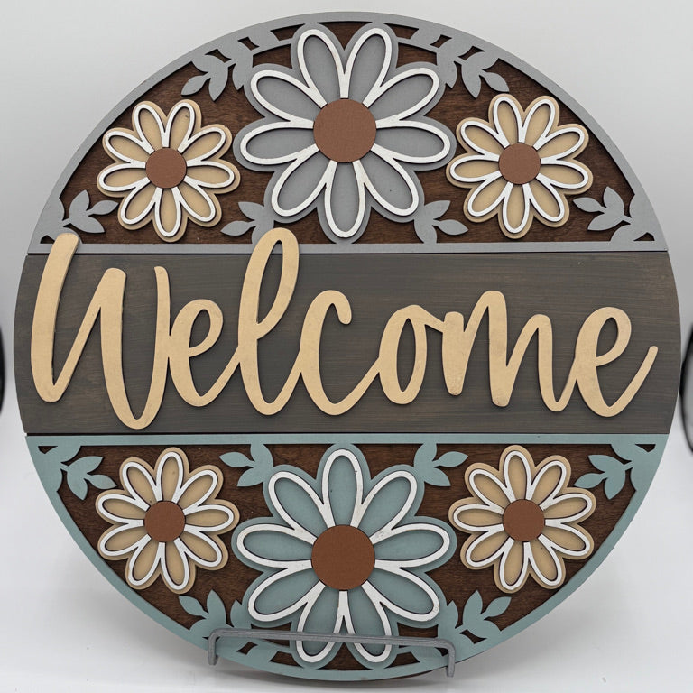 Layered floral wooden welcome sign created in DIY workshop.