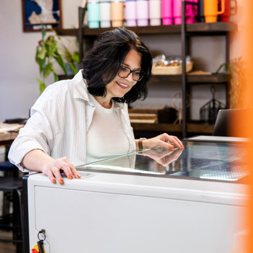 Woman engraving custom products in Foxwood Engraving studio in Renton, Washington