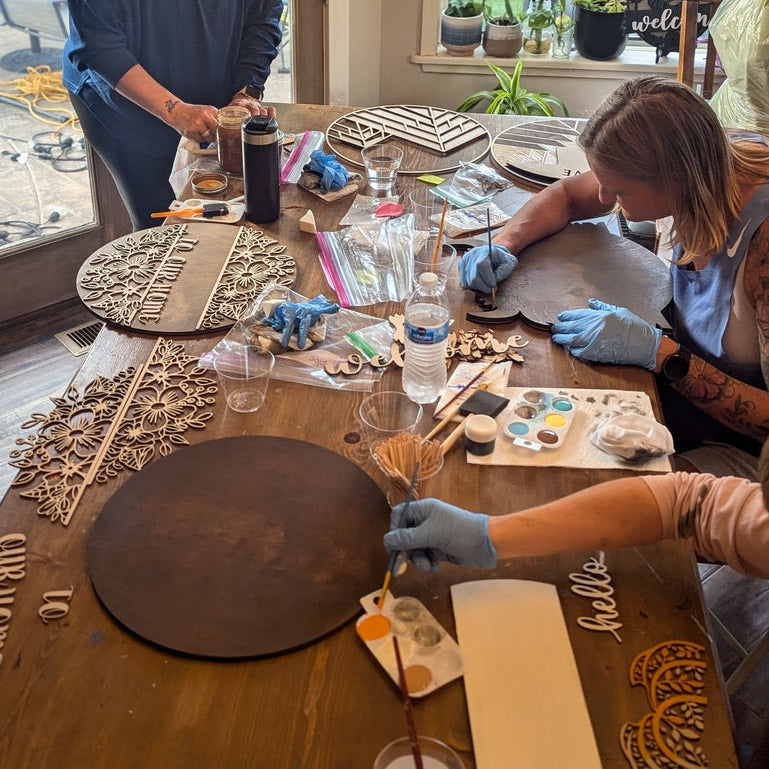 Group activity creating wooden welcome and seasonal signs together.