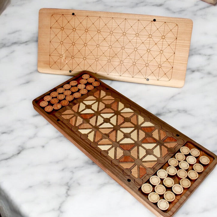 Handcrafted wooden Fanorona strategy board made from walnut and maple.