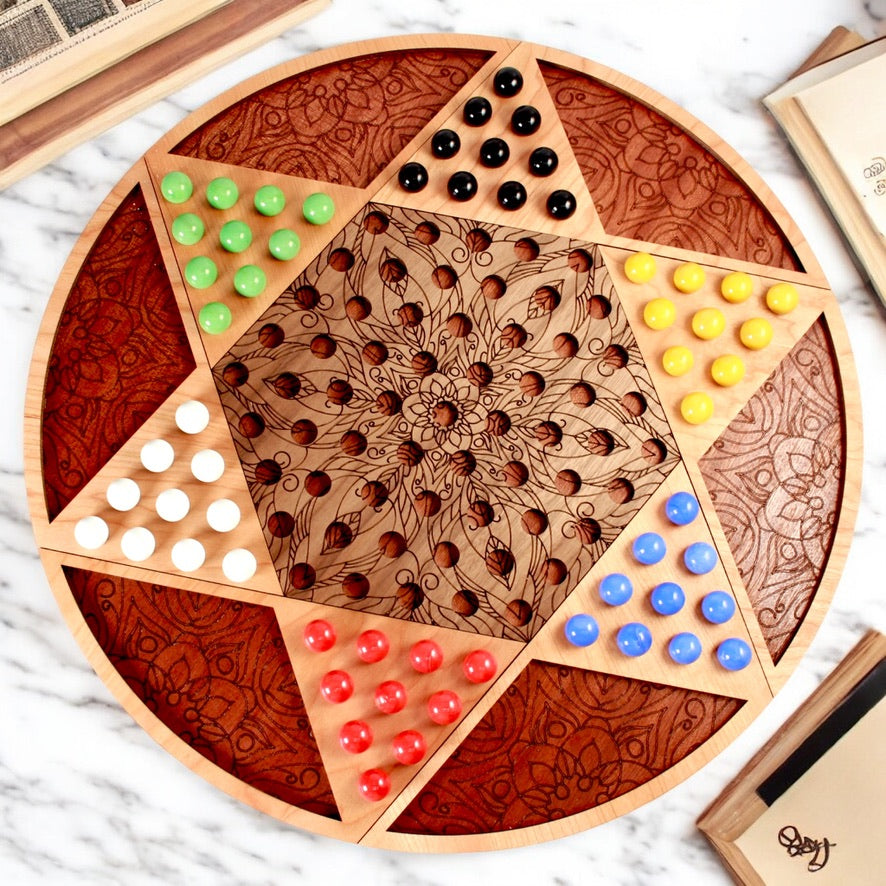 Handcrafted wooden Chinese Checkers board with engraved mandala design.