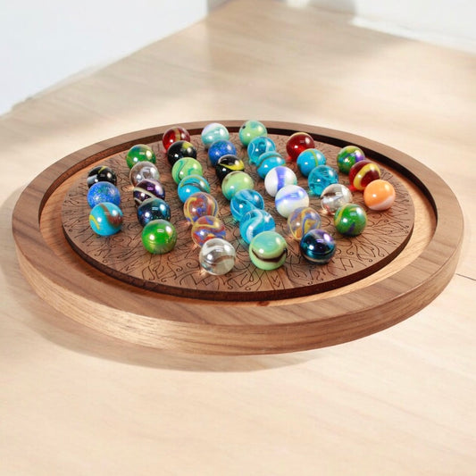 Handcrafted wooden marble solitaire game board with colorful marbles.