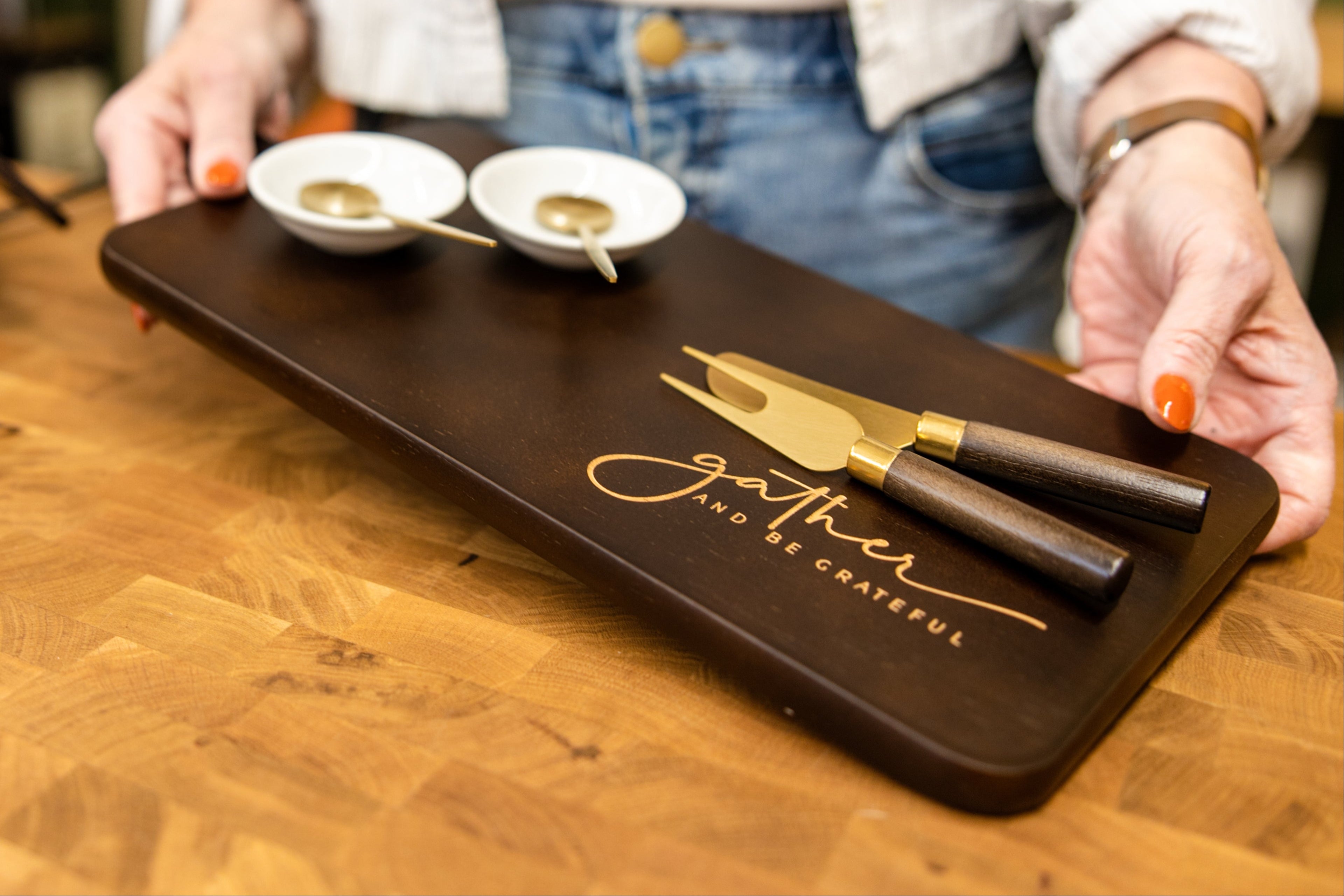 Custom engraved walnut charcuterie board with cheese knives, showcasing handcrafted personalized gifts created by Foxwood Engraving.