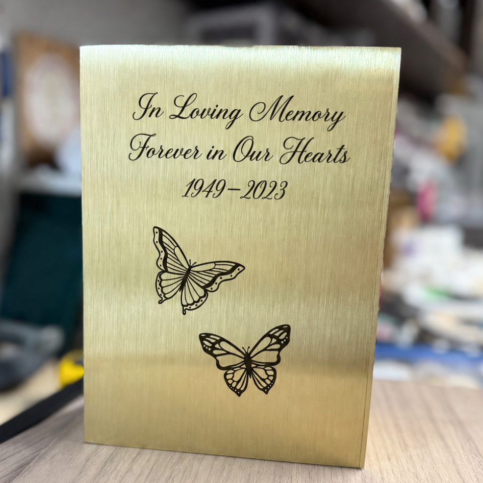 Brushed gold-tone memorial urn engraved with remembrance text, memorial dates and two butterflies