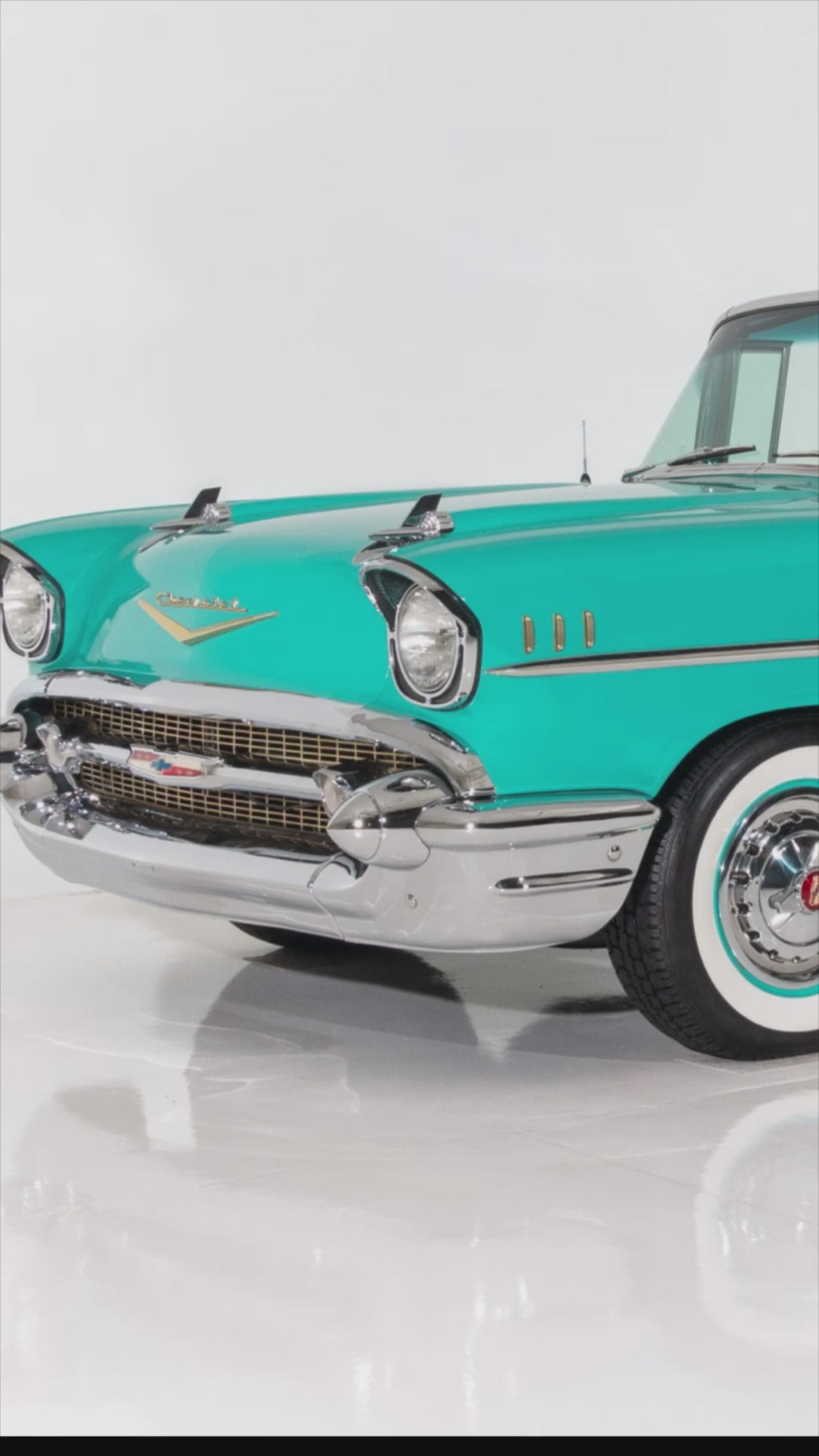 Video of Handcrafted layered wood wall art of a 1957 Chevy Bel Air in turquoise and chrome tones.