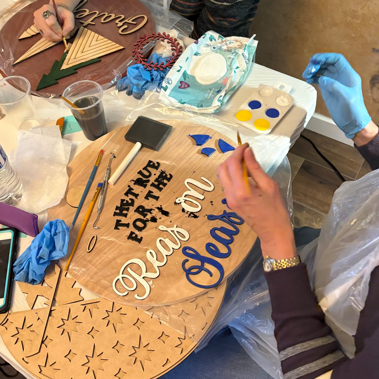 DIY creative class in Renton featuring handmade wooden welcome signs.