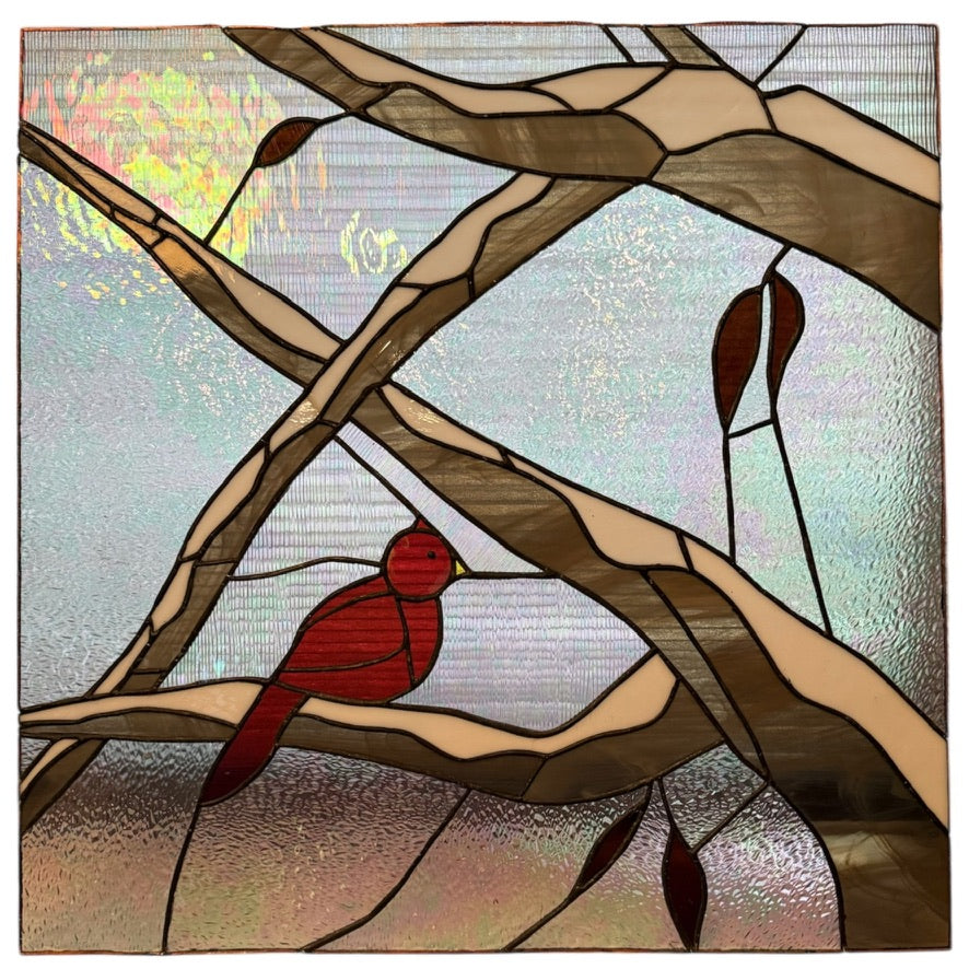 Handcrafted stained-glass panel featuring a red bird perched among tree branches.