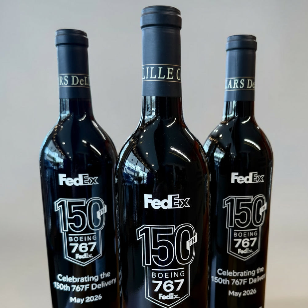 Three black wine bottles branding on a light gray background