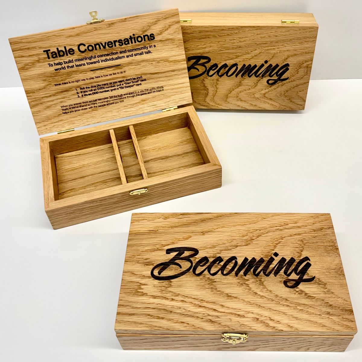 Custom-built wood conversation card boxes engraved with Becoming and Table Conversations artwork for the University of Washington basketball team.
