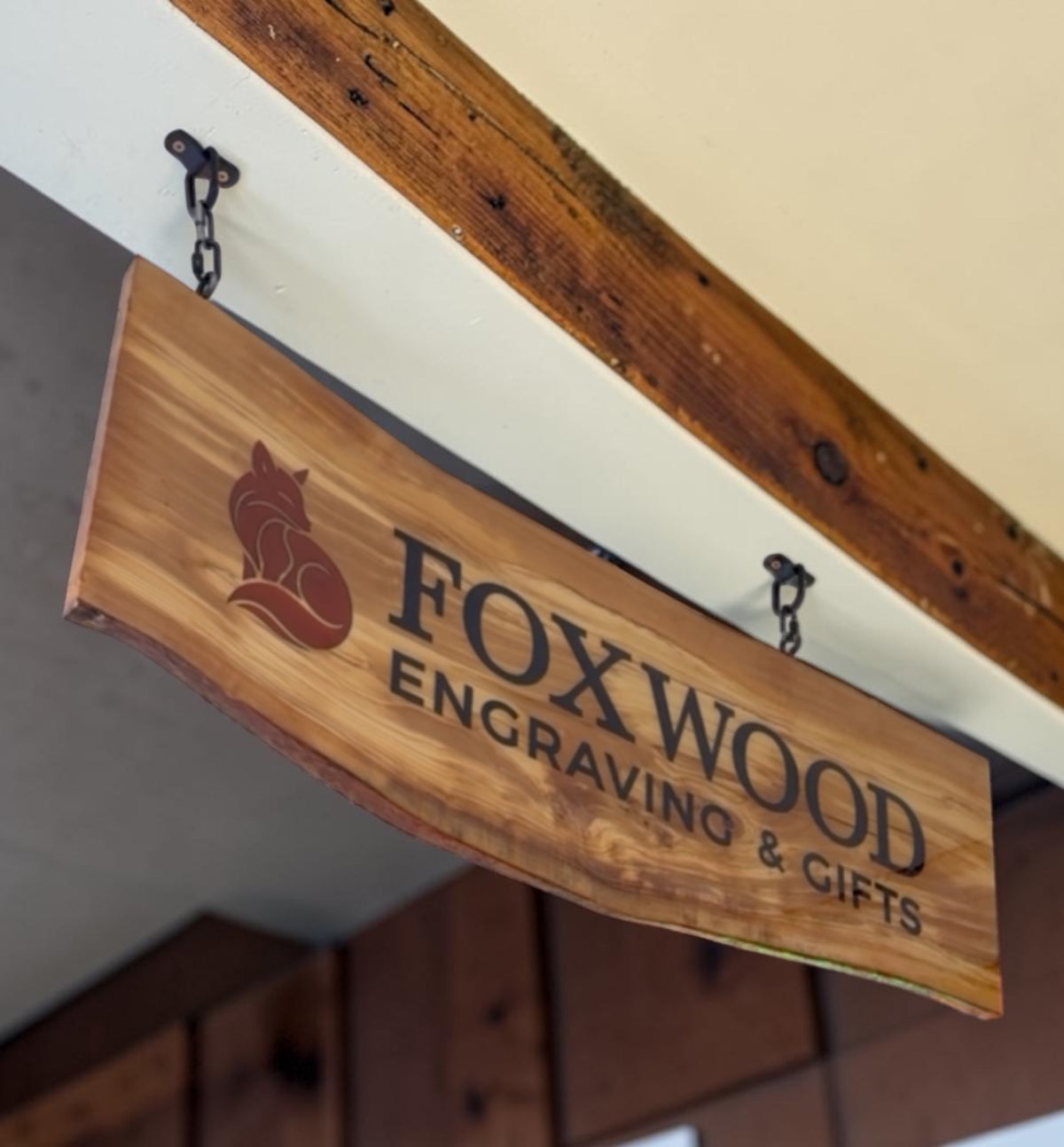 Custom hanging business sign made from wood and resin with dimensional Foxwood Engraving lettering.