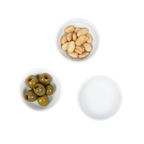Three white ceramic bowls for nuts, olives, dips, and sauces