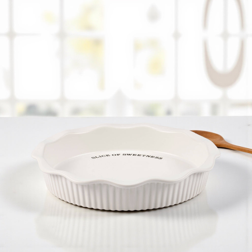 Simple white stoneware pie dish with debossed text inside rim.