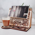 Wooden reading valet holding an open book with coffee mug nearby